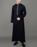 full length angled view of jet black thobe with gold geometric embroidered placket and collar