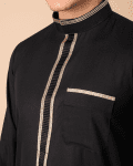 Close-up of gold contrast trim on black thobe placket and band collar