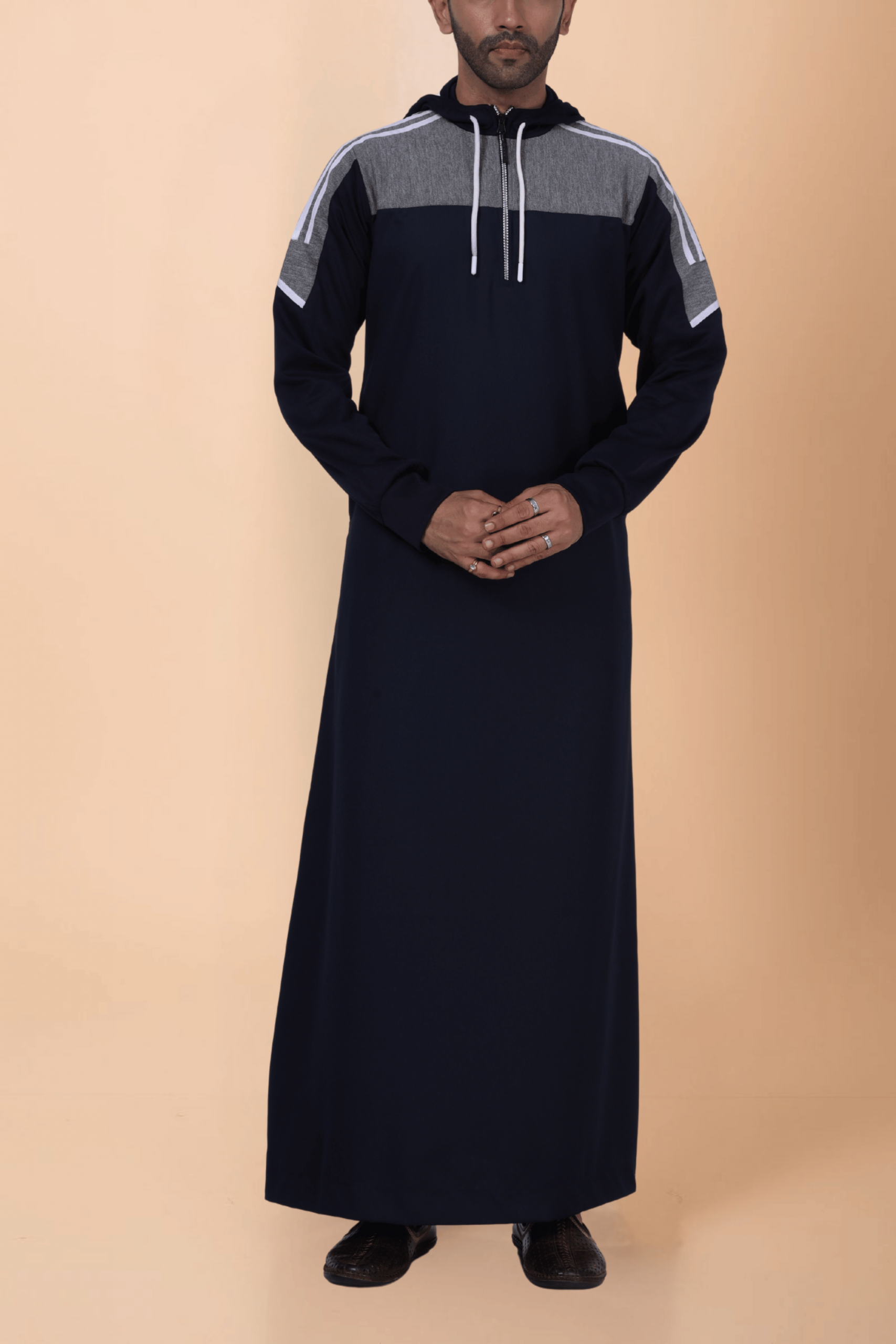 Navy Blue Hooded Thobe with Grey Panel and White Stripes Men wearing navy blue hooded thobe with grey panel, white stripe design and zip front hood