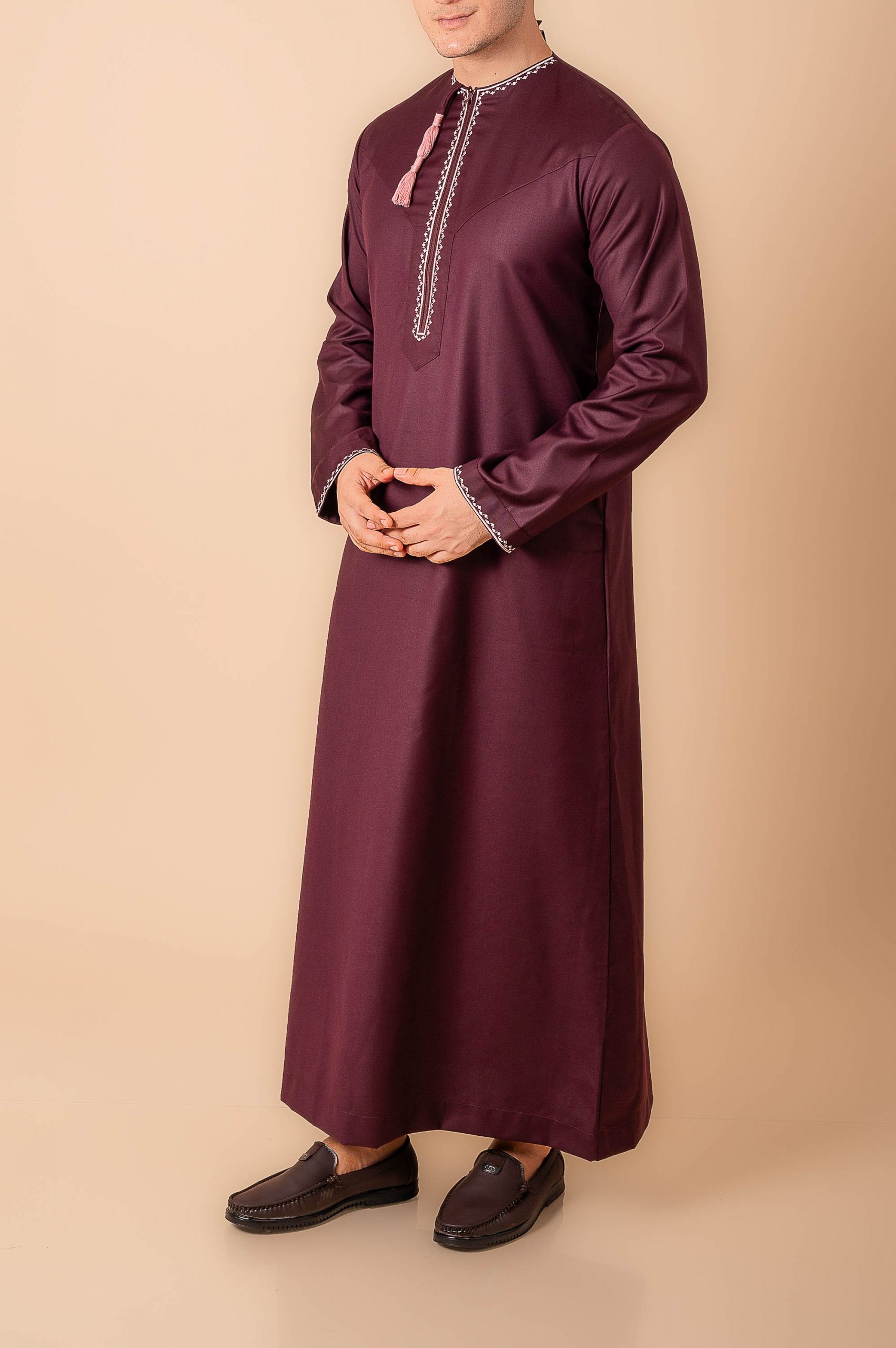 Maroon Omani thobe with white geometric embroidery and tassel for men