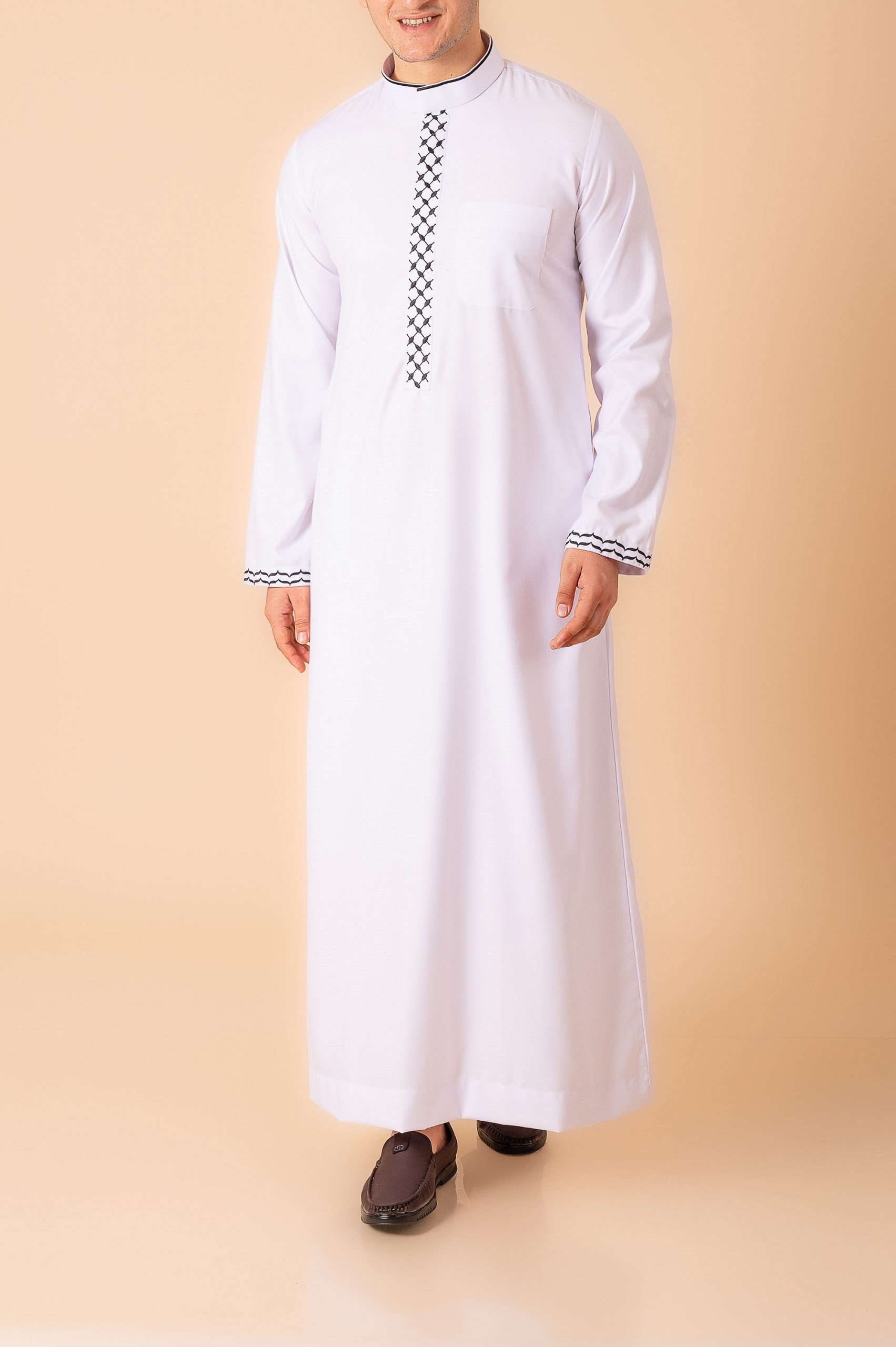Men’s classic white thobe with black lattice embroidery strip and contrast cuff trim front view