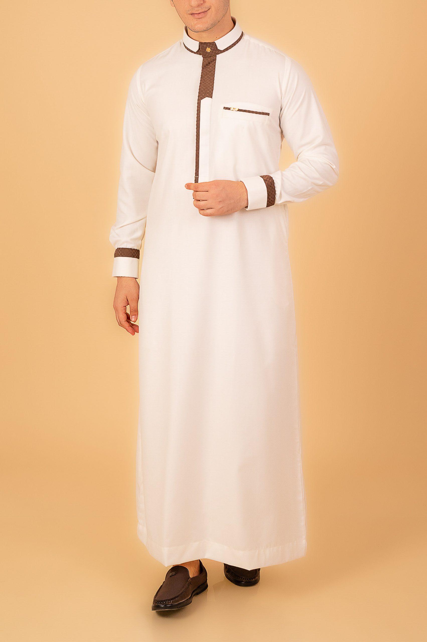 White Designer Thobe with Brown Contrast Piping – Men’s Saudi Collar Kandura men white designer thobe with brown contrast piping saudi collar kandura and pocket trim