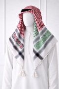 Traditional white keffiyeh shemagh scarf featuring red, green and black woven patterns with decorative tassel edges worn with a white thobe.