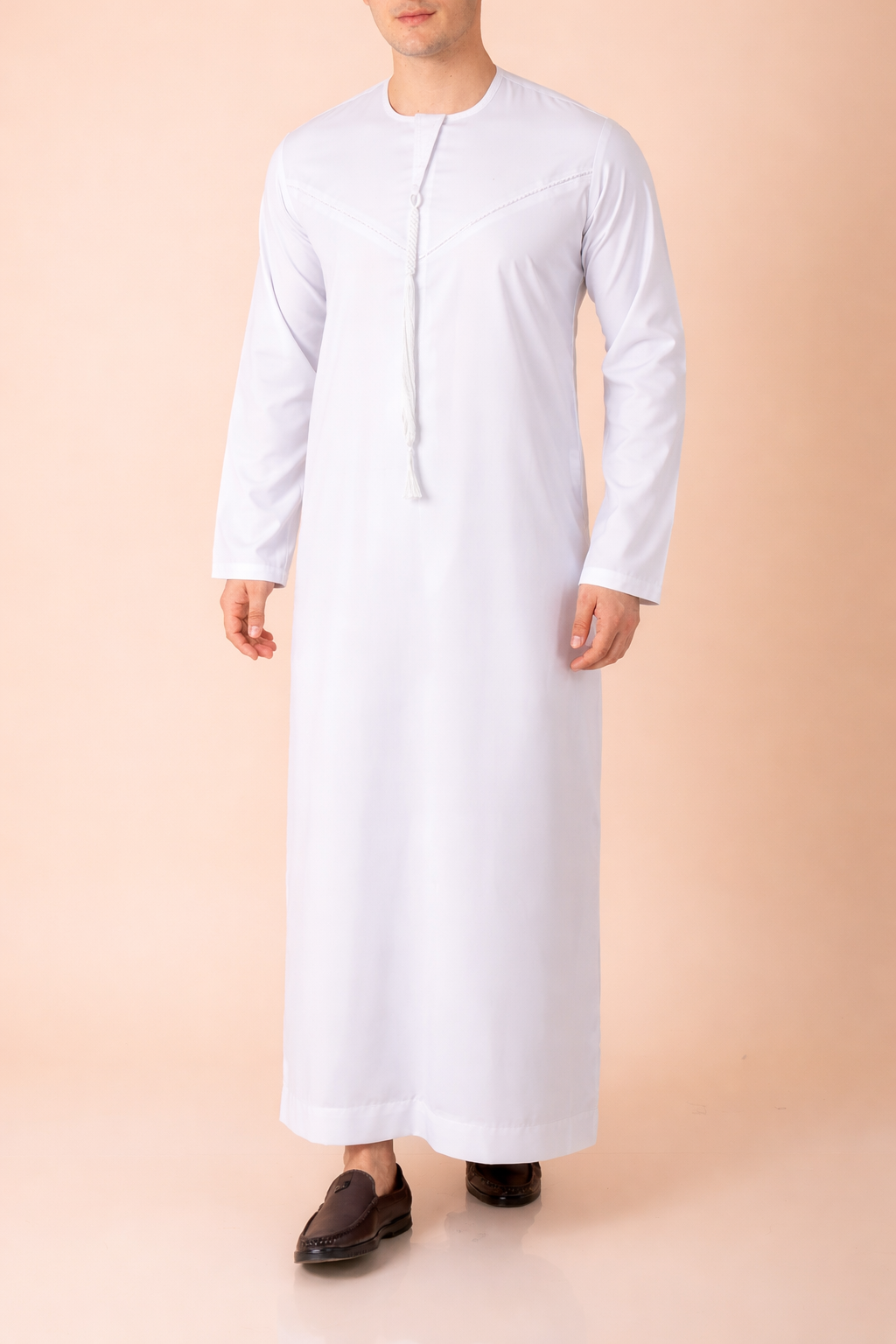 Pure white Emirati tassel thobe with tonal embroidered chest and sleeve detailing