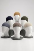 Six assorted colors of men's diamond-pattern knit Muslim prayer caps arranged neatly on a clean background.