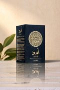 Lattafa Asad 100ml perfume for men in a luxury black and gold bottle with a circular lion crest shield next to its original packaging box.